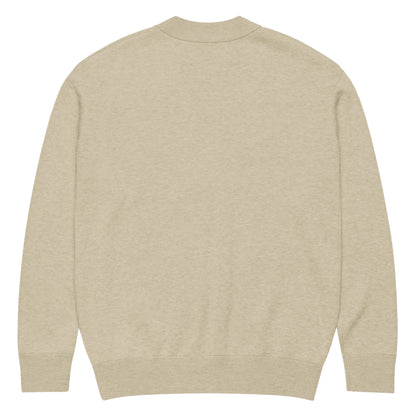 Parte trasera del cárdigan KÖNE beige mostrando acabado liso y estructura de punto uniforme.